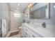 An elegant bathroom featuring dual vanity sinks, walk in shower, and modern fixtures at 4751 Baywood Point S Dr, Gulfport, FL 33711