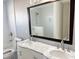 Bathroom featuring double sink vanity with marble countertop, dark wood framed mirror, tile flooring, and neutral paint at 4751 Baywood Point S Dr, Gulfport, FL 33711