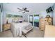 Bedroom with sliding glass doors to the outdoors; includes neutral furniture and accessories at 4751 Baywood Point S Dr, Gulfport, FL 33711