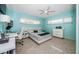 Bright bedroom with turquoise walls, natural light, and modern furnishings at 4751 Baywood Point S Dr, Gulfport, FL 33711