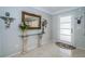 Elegant entryway with decorative mirror, console table, and terrazzo flooring at 4751 Baywood Point S Dr, Gulfport, FL 33711