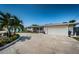 Single-story home featuring well-kept landscaping, paved driveway, and an attached two-car garage at 4751 Baywood Point S Dr, Gulfport, FL 33711