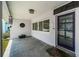 Inviting front porch with a decorative wind chime, a patterned rug, and plants in pots at 4751 Baywood Point S Dr, Gulfport, FL 33711