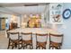 Kitchen island featuring barstool seating, designer pendant lights, and an open view to the main kitchen at 4751 Baywood Point S Dr, Gulfport, FL 33711