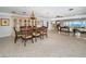 Open-concept living and dining area with terrazzo floors, stylish furniture, and water views at 4751 Baywood Point S Dr, Gulfport, FL 33711