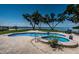 Beautiful pool and spa with brick paver deck and landscaping overlooking waterfront and bay at 4751 Baywood Point S Dr, Gulfport, FL 33711