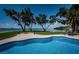 Sparkling pool with blue water, brick paver patio, and lawn overlooking the bay at 4751 Baywood Point S Dr, Gulfport, FL 33711