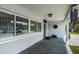 Inviting porch with decorative tile flooring, a stylish light fixture, and charming wind chimes at 4751 Baywood Point S Dr, Gulfport, FL 33711