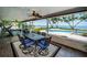 Enclosed sunroom with dining table and chairs, ceiling fan, and waterfront views at 4751 Baywood Point S Dr, Gulfport, FL 33711