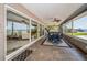 Enclosed sunroom with tile flooring, ceiling fans, and access to pool and backyard at 4751 Baywood Point S Dr, Gulfport, FL 33711