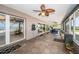 Enclosed sunroom with tile floors, ceiling fans, and access to pool and backyard at 4751 Baywood Point S Dr, Gulfport, FL 33711