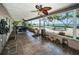 Enclosed sunroom with tile flooring, ceiling fans, and views of the pool and bay at 4751 Baywood Point S Dr, Gulfport, FL 33711