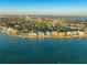 Expansive aerial view featuring waterfront houses, lush greenery, and the inter coastal from a distance at 774 Nina Dr, Tierra Verde, FL 33715