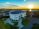 Waterfront mansion with a circular driveway and sunset views at 774 Nina Dr, Tierra Verde, FL 33715