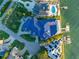 Aerial view of a home with an expansive blue roof, pool and private dock on waterfront property at 774 Nina Dr, Tierra Verde, FL 33715