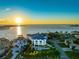 Panoramic aerial view of a luxurious waterfront home showcasing architecture and tropical landscaping at 774 Nina Dr, Tierra Verde, FL 33715