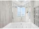 Bright bathroom with luxurious soaking tub, and dual shower at 774 Nina Dr, Tierra Verde, FL 33715