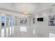 Spacious bedroom with water views, chandelier, and access to a private balcony at 774 Nina Dr, Tierra Verde, FL 33715