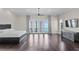 Spacious bedroom featuring hardwood floors, custom lighting, and balcony access at 774 Nina Dr, Tierra Verde, FL 33715
