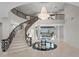 Grand foyer with winding staircase, detailed ironwork, chandelier, and marble floors creates a luxurious entrance at 774 Nina Dr, Tierra Verde, FL 33715