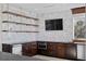 Bright kitchen features stainless steel appliances, open shelving and dark cabinets at 774 Nina Dr, Tierra Verde, FL 33715