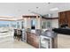 Bright open kitchen with a large island, beverage refrigerators and stunning views of the water at 774 Nina Dr, Tierra Verde, FL 33715