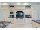 Luxury kitchen with custom white cabinetry, marble countertops and high-end appliances at 774 Nina Dr, Tierra Verde, FL 33715