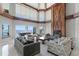 Bright living room boasts a soaring ceiling, huge windows, and cozy seating overlooking ocean views at 774 Nina Dr, Tierra Verde, FL 33715