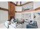 A two-story living room exhibits a sleek fireplace, large furniture, and a balcony overlooking the first floor at 774 Nina Dr, Tierra Verde, FL 33715