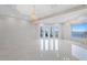 Bright and airy living room featuring marble floors, waterfront views, and access to the balcony at 774 Nina Dr, Tierra Verde, FL 33715