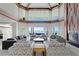 Elegant living room with a fireplace, views, and comfortable seating for entertaining guests at 774 Nina Dr, Tierra Verde, FL 33715