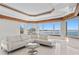 Modern bright living area with water view and a sleek modern sofa, perfect for entertaining at 774 Nina Dr, Tierra Verde, FL 33715