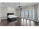 A spacious bedroom boasts hardwood floors, recessed lighting, and access to the balcony overlooking the water at 774 Nina Dr, Tierra Verde, FL 33715