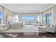 Bright main bedroom featuring a seating area, plush carpet, balcony access, and abundant natural light at 774 Nina Dr, Tierra Verde, FL 33715