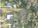Aerial view of the property highlighting the large lot, mature trees, and layout of the home and surrounding buildings at 7809 Alafia Dr, Riverview, FL 33578