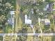 An aerial view of the property showcasing its well-manicured lawn, spacious layout, and proximity to neighboring homes at 7809 Alafia Dr, Riverview, FL 33578