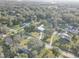 Property aerial view showing location within a community with mature trees and the property's manicured lawn at 7809 Alafia Dr, Riverview, FL 33578