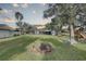 Expansive backyard with a fire pit, playground, and a covered patio, perfect for outdoor entertaining and relaxation at 7809 Alafia Dr, Riverview, FL 33578