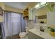 Bathroom featuring a vanity, sink, mirror, shower with curtain and an overhead cabinet at 7809 Alafia Dr, Riverview, FL 33578