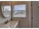 Bright bathroom featuring a modern sink, a window, and a door that leads outside at 7809 Alafia Dr, Riverview, FL 33578