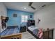 This bedroom has a fan, a window and two beds with wood-look vinyl floors at 7809 Alafia Dr, Riverview, FL 33578