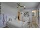 Charming bedroom with a ceiling fan, a painting of horses, and an ensuite bathroom at 7809 Alafia Dr, Riverview, FL 33578