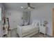 Bright bedroom with white furniture, wood-look floors, and a ceiling fan at 7809 Alafia Dr, Riverview, FL 33578