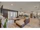 Spacious open-concept living room with hardwood floors and French doors to backyard at 7809 Alafia Dr, Riverview, FL 33578