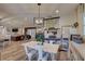 Open-concept living space with white dining table, piano, and view of the living room at 7809 Alafia Dr, Riverview, FL 33578