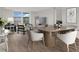 Bright dining room with light wood floors and a modern dining table at 9 Haig Pl # 612, Dunedin, FL 34698