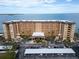 Aerial view of a waterfront condo building with parking and a waterfront view at 9 Haig Pl # 612, Dunedin, FL 34698