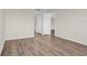 Bedroom with wood-look floors and access to another room at 9 Haig Pl # 612, Dunedin, FL 34698