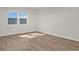 Bedroom with large window and wood-look flooring at 9 Haig Pl # 612, Dunedin, FL 34698