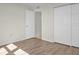Bedroom with wood-look floors and double door closet at 9 Haig Pl # 612, Dunedin, FL 34698